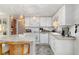 Well-lit kitchen with white cabinetry, modern appliances, and a functional layout with bar stool seating at 491 Cervina Dr, Venice, FL 34285