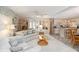 Bright living room featuring neutral décor, plush seating, and an open layout connected to the kitchen at 491 Cervina Dr, Venice, FL 34285