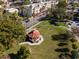 Aerial shot featuring a park gazebo, green lawn, sidewalk and surrounding buildings at 491 Cervina Dr, Venice, FL 34285