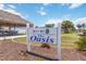 Welcome to Venice Isle The Oasis community sign with lush landscaping and bright blue sky at 491 Cervina Dr, Venice, FL 34285