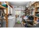 Functional utility room with washer, shelving, work area, and organized storage solutions at 491 Cervina Dr, Venice, FL 34285