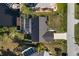 Aerial view of a home with a screened patio, surrounded by a well-maintained yard and neighborhood at 5140 Administration St, Port Charlotte, FL 33948