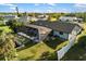 Aerial view of a single-Gathering home with a screened-in pool and lush backyard, nestled in a quiet neighborhood at 5140 Administration St, Port Charlotte, FL 33948