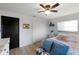Bright bedroom features a ceiling fan, a dark door, a wardrobe closet, and a comfortable-looking bed at 5140 Administration St, Port Charlotte, FL 33948