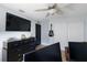 Well-organized bedroom featuring wood-look floors, a ceiling fan, a dark door and dresser, and a closet at 5140 Administration St, Port Charlotte, FL 33948