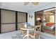 Cozy dining area with seating for two and a view of the bedroom through sliding glass doors, perfect for enjoying meals at 5140 Administration St, Port Charlotte, FL 33948