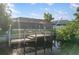 A private backyard dock with seating area and screened-in lanai provides waterfront relaxation at 5140 Administration St, Port Charlotte, FL 33948