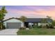 Charming single-story home featuring a lush front yard, well-maintained landscaping, and a two-car garage at 5140 Administration St, Port Charlotte, FL 33948