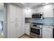 Well-equipped kitchen with stainless steel appliances, granite countertops, and ample cabinet space at 5140 Administration St, Port Charlotte, FL 33948