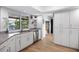 Bright kitchen featuring white cabinets, granite countertops, stainless steel appliances, and a view of the waterfront at 5140 Administration St, Port Charlotte, FL 33948