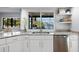 Modern kitchen sink with granite counters and views of a serene waterfront setting at 5140 Administration St, Port Charlotte, FL 33948