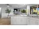 Open kitchen with granite countertops, white cabinets, and views of the backyard at 5140 Administration St, Port Charlotte, FL 33948