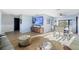 Bright living room featuring modern decor, wood floors, entertainment center, and large windows overlooking water views at 5140 Administration St, Port Charlotte, FL 33948
