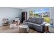 Comfortable living room featuring a reclining sofa, armchair, side tables, and a large window at 5140 Administration St, Port Charlotte, FL 33948