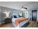 Serene bedroom with wood-look flooring, stylish decor, and ensuite bathroom at 5140 Administration St, Port Charlotte, FL 33948