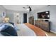 Light and airy main bedroom with wood-look flooring and a view of the ensuite bathroom at 5140 Administration St, Port Charlotte, FL 33948