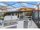 Outdoor kitchen featuring a stainless steel grill, countertop bar, and refrigeration, perfect for outdoor dining and entertaining at 5140 Administration St, Port Charlotte, FL 33948