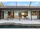 Enjoy this patio with a dining area and lounge chairs, perfect for relaxing by the pool in the screened-in lanai at 5140 Administration St, Port Charlotte, FL 33948