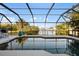 Relaxing enclosed pool and scenic canal view, perfect for cooling off and enjoying waterfront serenity at 5140 Administration St, Port Charlotte, FL 33948