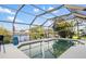 Enjoy the outdoors in this screened-in pool with views of the beautiful canal and blue skies at 5140 Administration St, Port Charlotte, FL 33948
