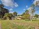 Expansive backyard with lawn and landscaping provides a serene outdoor space at 602 Bonito Ave, Nokomis, FL 34275