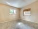 Bright bedroom with neutral walls, two windows, and classic patterned flooring at 602 Bonito Ave, Nokomis, FL 34275