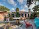 Charming home exterior featuring a no diving sign, table with chairs, and lush tropical landscaping at 602 Bonito Ave, Nokomis, FL 34275