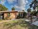 Exterior view of a charming home with tropical landscaping and brick elements at 602 Bonito Ave, Nokomis, FL 34275
