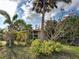 Charming single-story home featuring mature trees, native plants, and a well-manicured lawn at 602 Bonito Ave, Nokomis, FL 34275