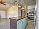 Open kitchen featuring a center island with a tile countertop, updated appliances, and ample cabinet space at 602 Bonito Ave, Nokomis, FL 34275