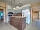 Open kitchen featuring an island, stainless appliances, and stylish backsplash at 602 Bonito Ave, Nokomis, FL 34275
