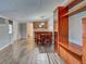 Open living area with kitchenette, wood-look floors, built-in shelving, and a comfortable living space at 602 Bonito Ave, Nokomis, FL 34275