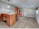 Spacious living room with wood-look floors, built-in shelving, and a functional kitchenette for convenience at 602 Bonito Ave, Nokomis, FL 34275