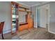 Bright living room with wood-look floors, built-in shelving, and an open layout creating a comfortable space at 602 Bonito Ave, Nokomis, FL 34275