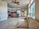 Spacious open-concept living room with a large windows, ceiling fan, and access to the kitchen at 602 Bonito Ave, Nokomis, FL 34275
