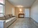 Cozy living room with a sofa, side table, and two entry doors at 602 Bonito Ave, Nokomis, FL 34275