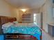 Large main bedroom showcases a spacious bed, wooden shelves, and doorway to a bright sunroom at 602 Bonito Ave, Nokomis, FL 34275