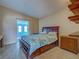 Main bedroom featuring a large bed, wood furniture, and doorway to a blue sunroom at 602 Bonito Ave, Nokomis, FL 34275