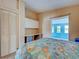 Main bedroom boasts workspace, closet, doorway to sunroom, and neutral walls at 602 Bonito Ave, Nokomis, FL 34275