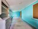 Spacious sunroom with blue walls, built-in cabinets, and plenty of natural light at 602 Bonito Ave, Nokomis, FL 34275