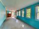 Bright and airy sunroom with blue walls, multiple windows, and ample natural light at 602 Bonito Ave, Nokomis, FL 34275