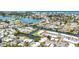 Birds eye view of waterfront homes in residential neighborhood with lush landscape and beautiful water access at 608 Fair Winds Dr # 608, Nokomis, FL 34275