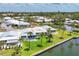 Aerial view of the property, showcasing backyard, canal, and lush landscaping at 608 Fair Winds Dr # 608, Nokomis, FL 34275