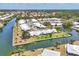 Wide aerial view of waterfront homes situated on canals with mature landscaping and tropical foliage at 608 Fair Winds Dr # 608, Nokomis, FL 34275