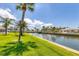 Beautiful backyard view of the canal and tropical landscaping at 608 Fair Winds Dr # 608, Nokomis, FL 34275