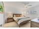 Cozy bedroom with a queen bed, ceiling fan, and neutral decor at 608 Fair Winds Dr # 608, Nokomis, FL 34275