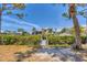 View of a private wooden dock for resident use in a serene setting with lush landscaping and foliage at 608 Fair Winds Dr # 608, Nokomis, FL 34275