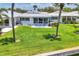 Landscaped backyard, patio area, and canal waterfront view at 608 Fair Winds Dr # 608, Nokomis, FL 34275