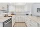 Modern kitchen with pristine white cabinets, sleek countertops, and stainless steel appliances, creating a clean aesthetic at 608 Fair Winds Dr # 608, Nokomis, FL 34275