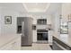 Updated kitchen with stainless steel appliances, white cabinetry, and convenient access to the outside at 608 Fair Winds Dr # 608, Nokomis, FL 34275